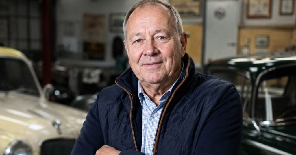 Derek Mathewson standing beside a classic car at his Mathewsons auction house in North Yorkshire, UK